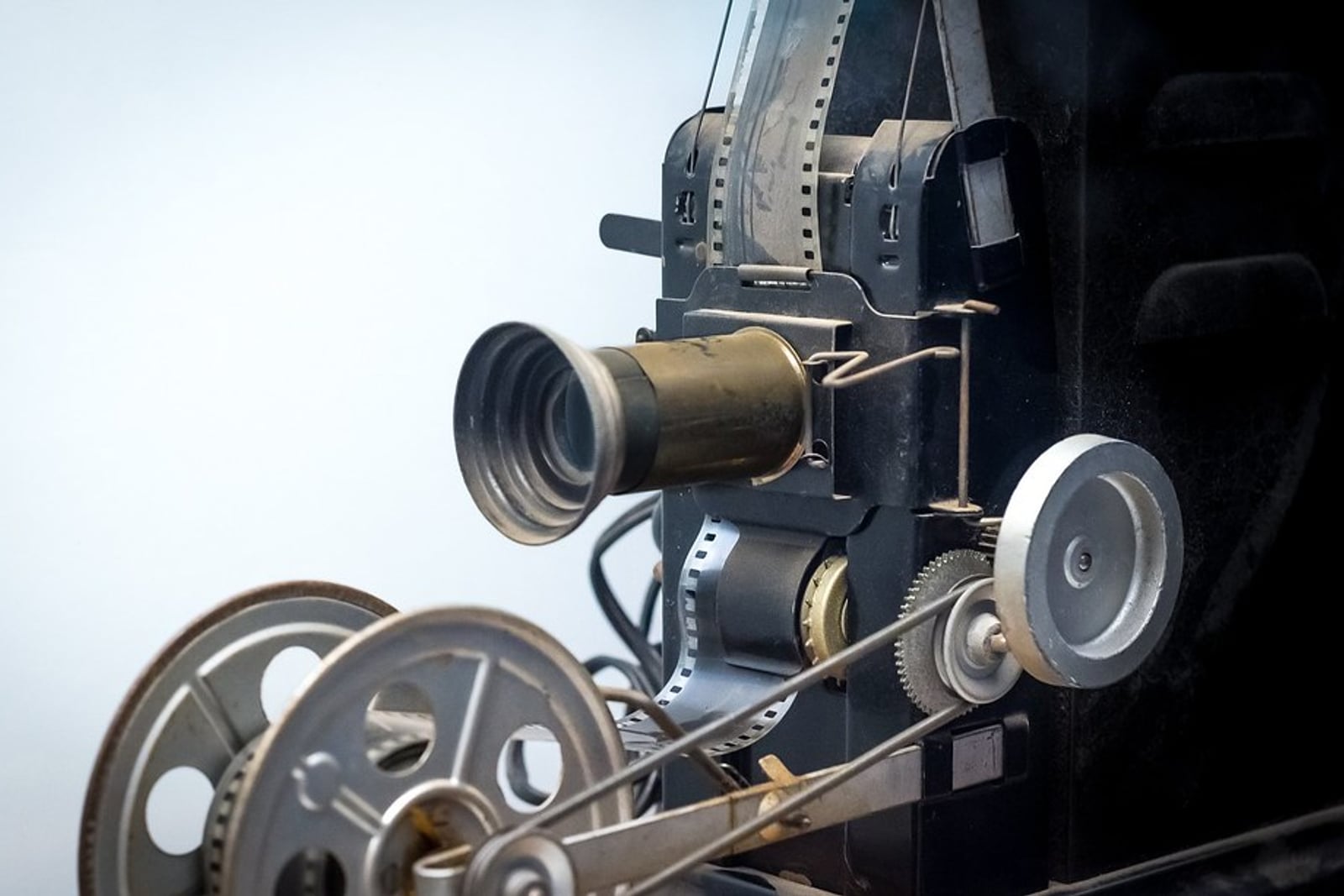 A strip of celluloid film beside film reels.