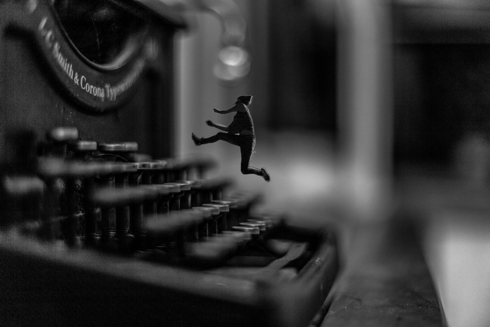 An old mechanical typewriter on a dark desk.