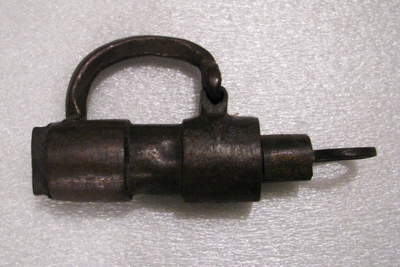 Padlock with two old keys on wood