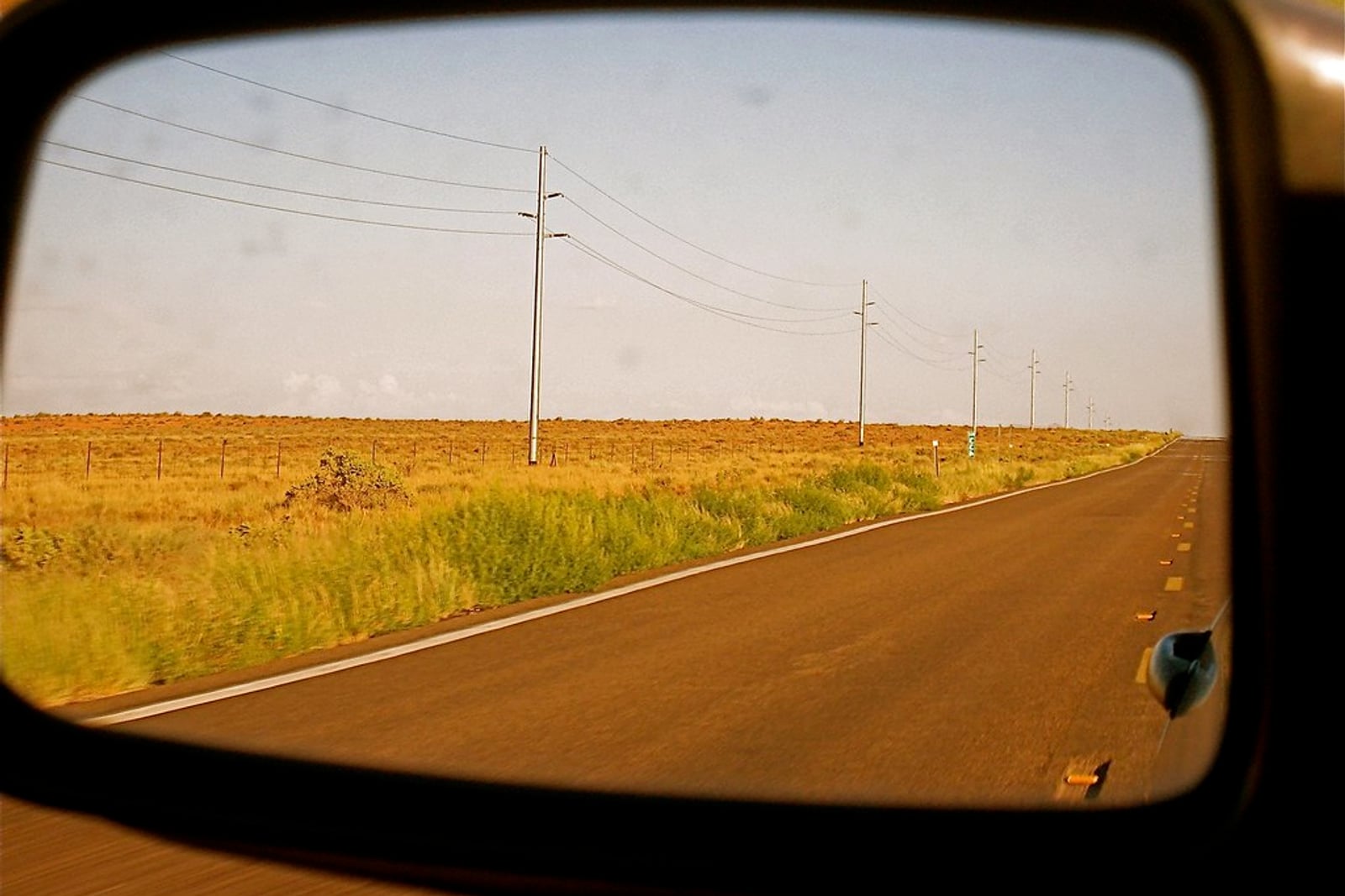 Empty open road between fields